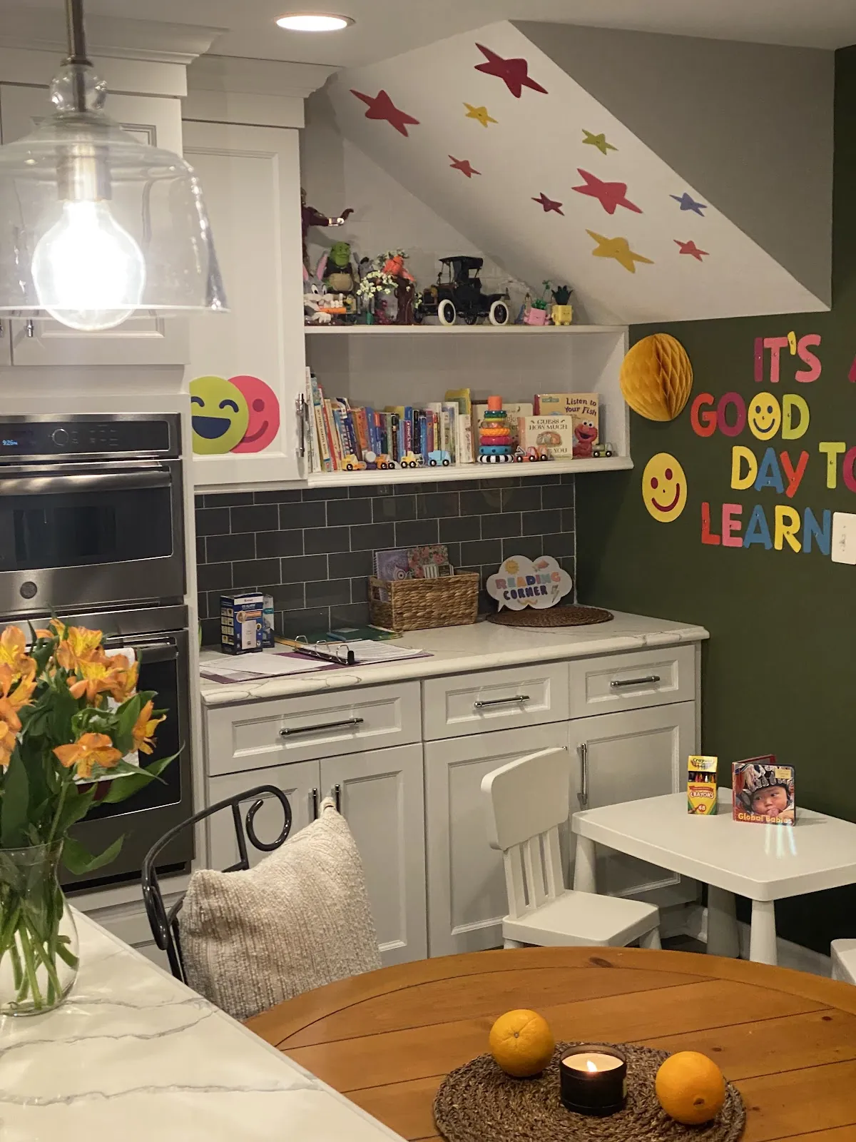 The craft and learning corner, with the children's artwork on the wall